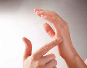 Woman doing EFT on the karate chop point. Emotional Freedom Techniques, tapping, a form of counseling intervention that draws on various theories of alternative medicine.